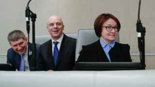 Министрам экономразвития Максиму Решетникову (слева) и финансов Антону Силуанову теперь не до смеха: экономика замедлилась, в бюджете штормит, и придется идти за деньгами к председателю ЦБ Эльвире Набиуллиной 