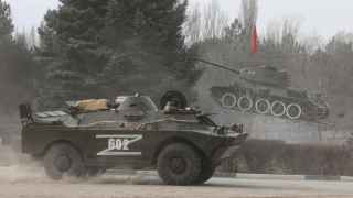 Russian Army military vehicle drives along a street in Armyansk